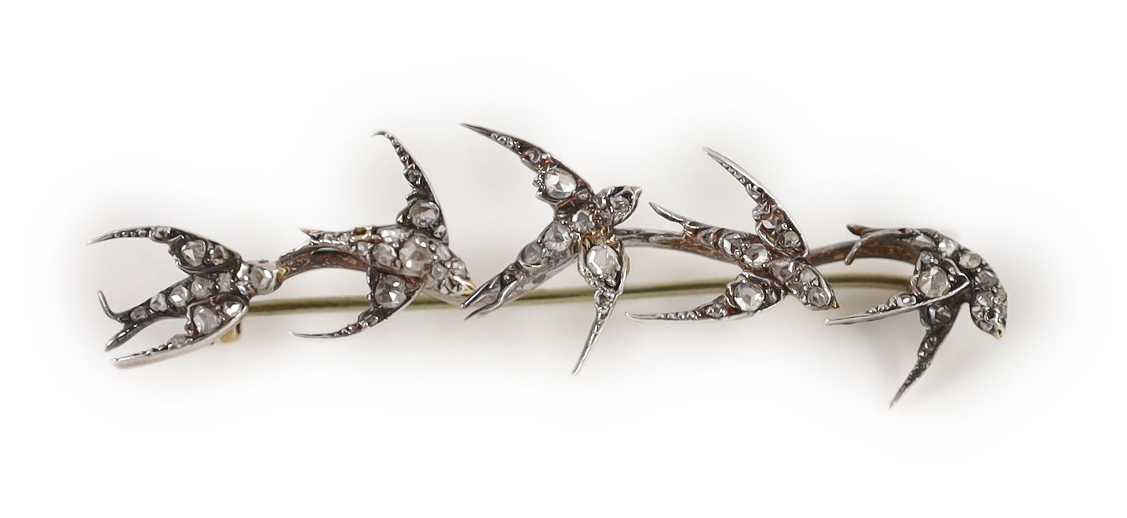 A late Victorian gold and rose cut diamond set brooch, modelled as five swallows in flight